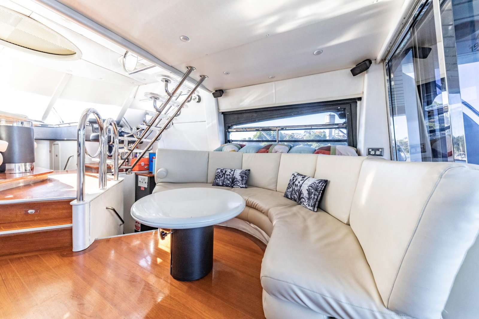Semi-enclosed dining area with curved white leather seating on MV state of the art