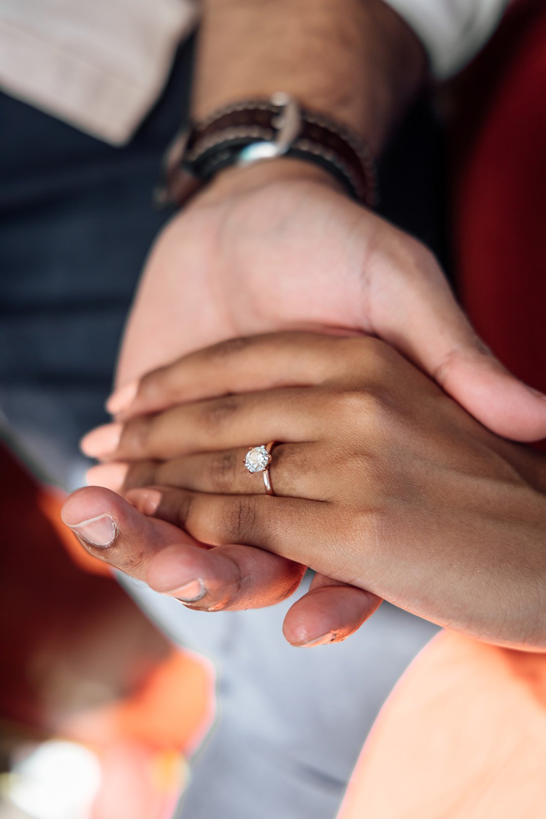 Close-up of engagement ring on woman’s hand.