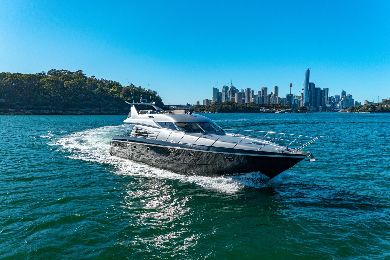 MV Sunseeker cruising past Sydney skyline on clear day.