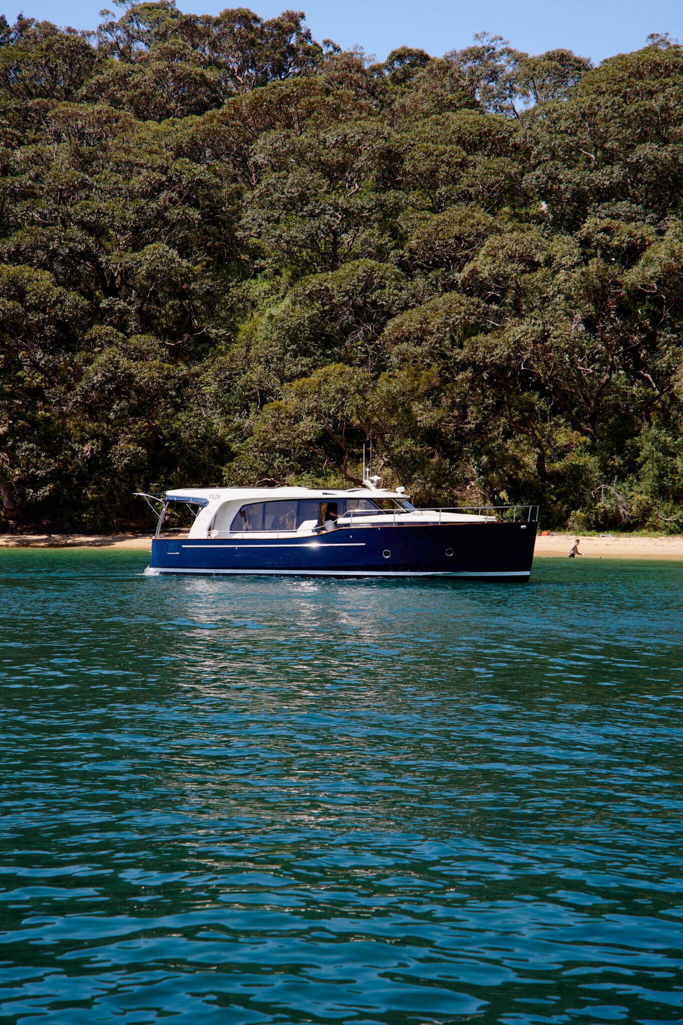 The Greenline 41 illuminated by soft evening light, cruising near the Sydney Opera House.