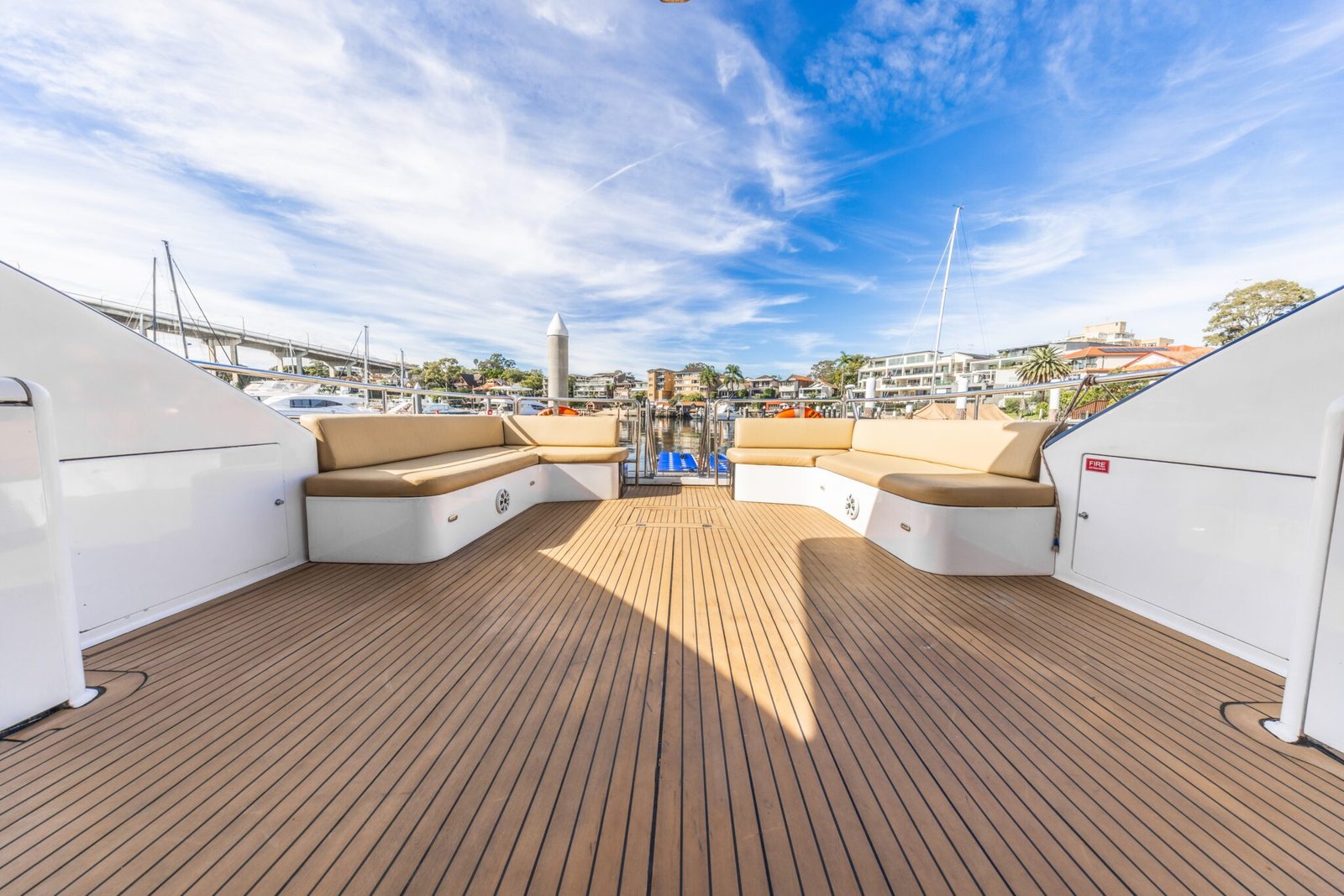 Sun deck with timber flooring and panoramic harbour view on MV Gravity