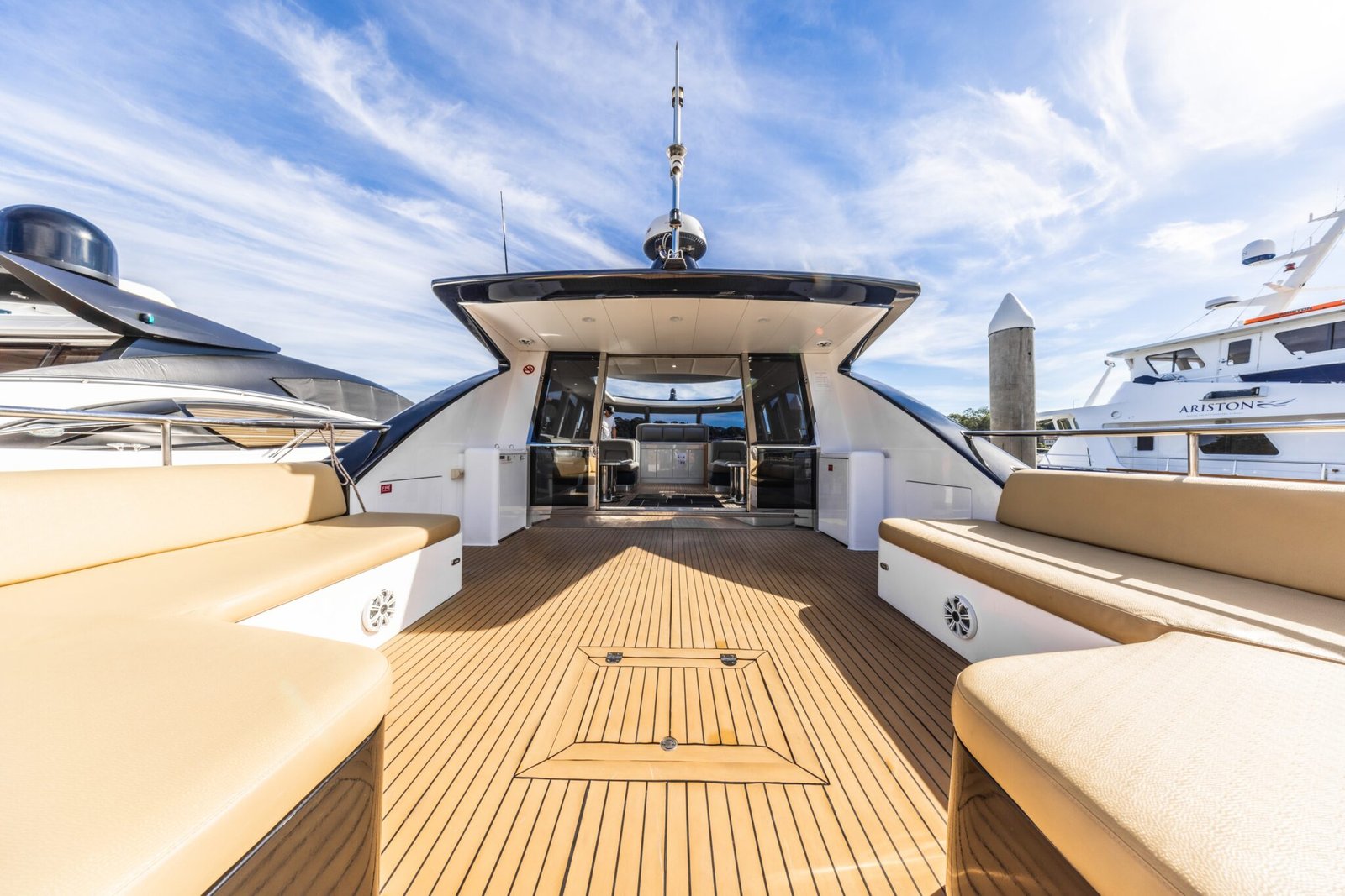 Bow of luxury vessel with sun loungers and Sydney skyline on MV Gravity