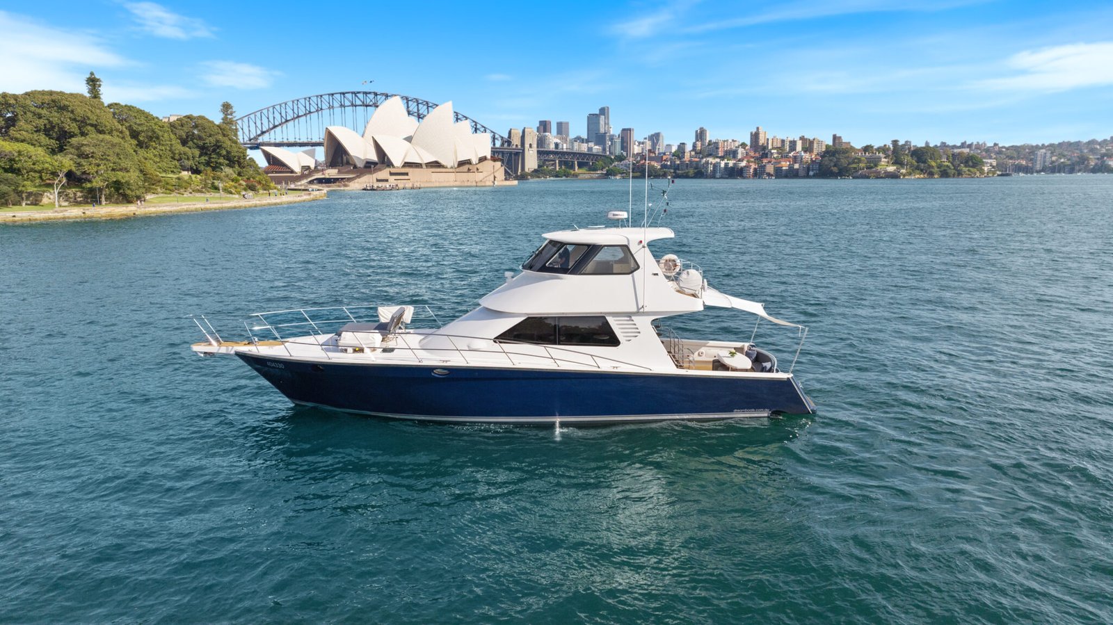 State of the Art luxury yacht on Sydney Harbour with the Sydney Opera House and Harbour Bridge in the background.